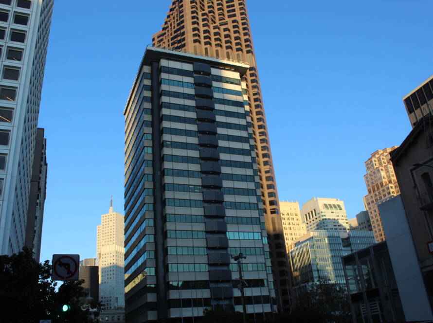 Tall central building rising above clustered towers in San Francisco’s financial district—symbolizing strategic elevation and clarity in crowded markets.