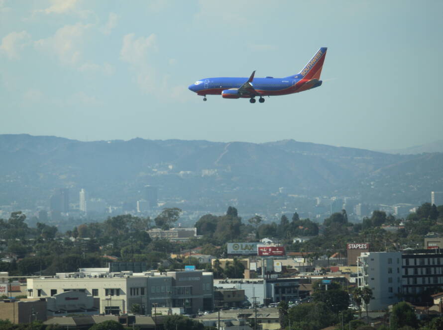 Southwest Airlines aircraft descending toward LAX with cityscape below, symbolizing strategic momentum for SME business growth