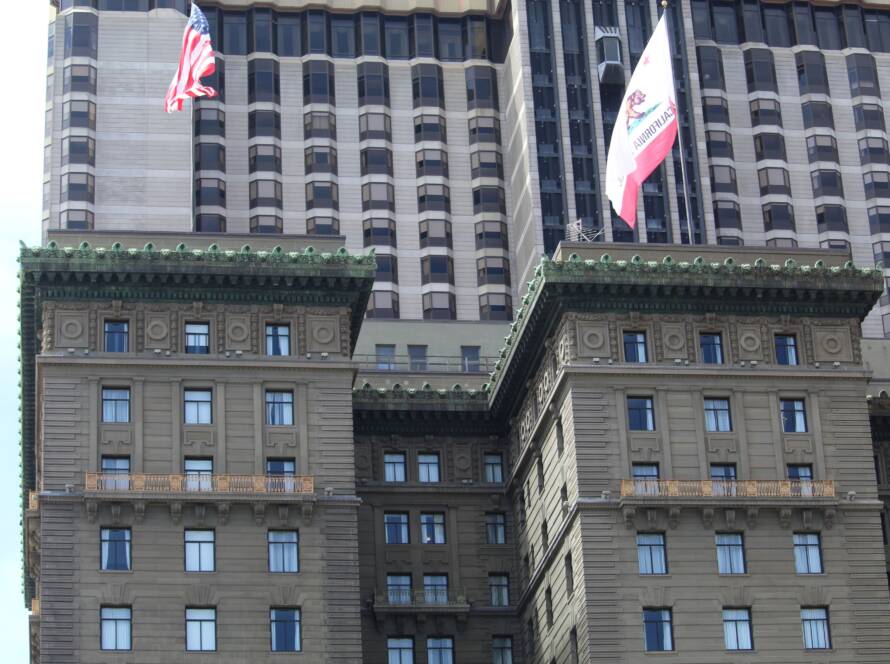 Ornate historic building beside a modern tower, illustrating how temporary supports and strategic capital bridge legacy operations and new growth initiatives