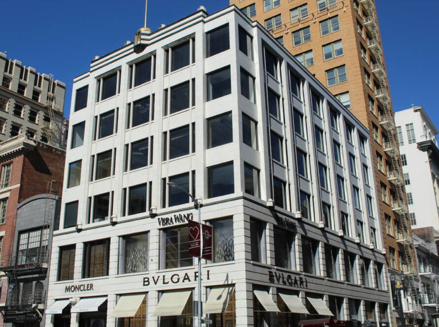 Modern retail building with luxury brand storefronts in busy city — symbolising SME visibility and strategic growth